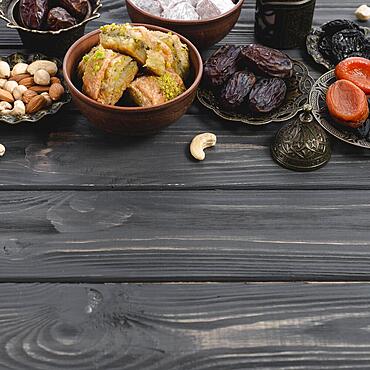 Turkish delight baklava sweets dried fruits nuts wooden desk