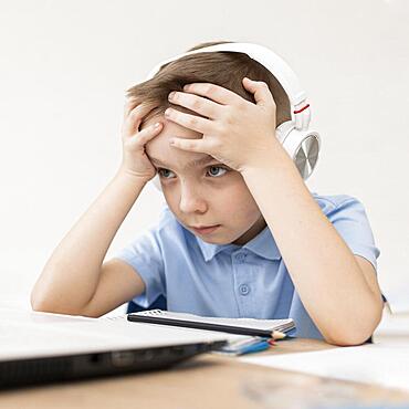 Medium shot tired kid with headphones