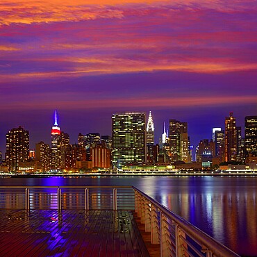 Manhattan New York skyline at sunset rainy dusk from East River NYC USA