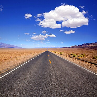 Badwater road Death Valley straight in desert to mountains National Park California