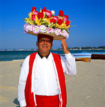 Flower seller on the beach, Hammamet, Cap Bon, Tunisia, North Africa, Africa