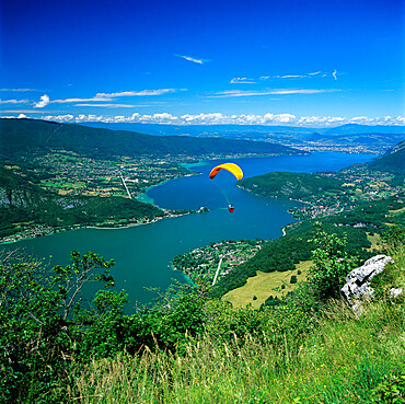 View over lake with paraglider, Lake Annecy, Rhone Alpes, France, Europe