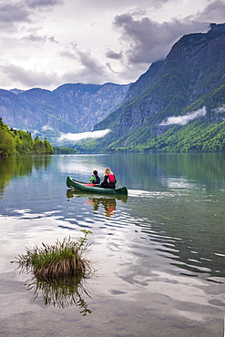 Mother and son canoeing on Lake Bohinj, Triglav National Park, Julian Alps, Slovenia, Europe