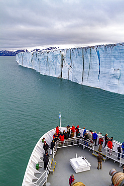 The Lindblad Expedition ship National Geographic Explorer near a glacier in the Svalbard Archipelago, Norway.