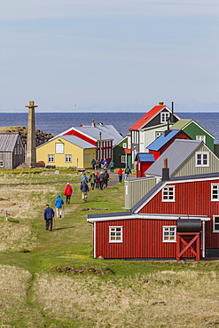 Tourists inspect remote Flatey Island, Iceland.