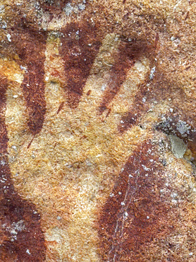 Ancient rock art painted on the limestone cliffs in Berau Bay on the island of Papua, Indonesia.
