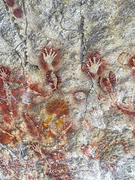 Ancient rock art painted on the limestone cliffs in Berau Bay on the island of Papua, Indonesia.