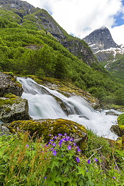 Slow shutter speed silky water of the Olden River as it flows along Briksdalen, Olden, Nordfjord, Norway, Scandinavia, Europe