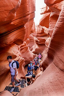 Tourists explore a slot canyon in Upper Antelope Canyon, Navajo Land, Arizona, United States of America, North America