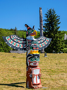 Kwakwaka'wakw totem poles in the cemetery in Alert Bay, Cormorant Island, British Columbia, Canada, North America