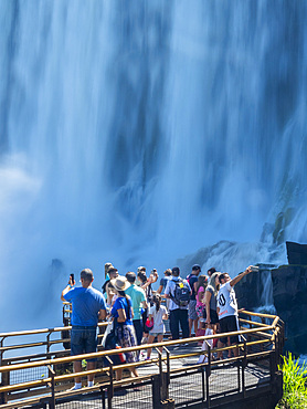 Tourists on a platform on the lower circuit at Iguazú Falls, Misiones Province, Argentina.