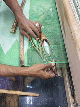 Egyptian man working on a loom in a shop at the unfinished obelisk in Aswan, Egypt, North Africa, Africa