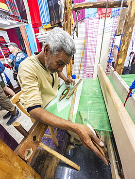 Egyptian man working on a loom in a shop at the unfinished obelisk in Aswan, Egypt, North Africa, Africa