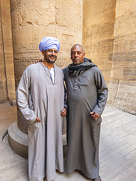 Two Egyptian men standing inside the Philae temple complex, The Temple of Isis, currently on the island of Agilkia, Egypt, North Africa, Africa