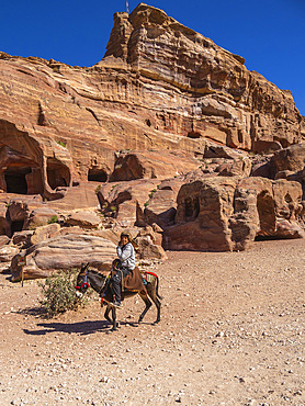 Donkey and rider, Petra Archaeological Park, UNESCO World Heritage Site, one of the New Seven Wonders of the World, Petra, Jordan, Middle East