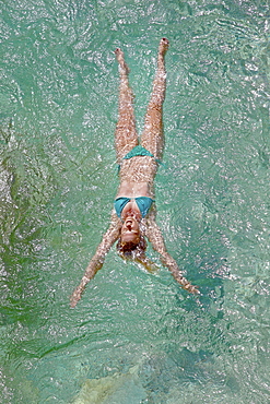 Young woman bathing in the river Soca, Alpe-Adria-Trail, Tolmin, Slovenia