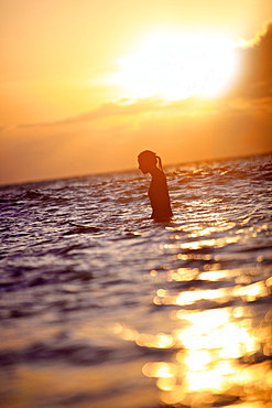 Female surfer waiting for a wave, Praia, Santiago, Cape Verde