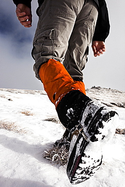 Hiker walking in snow, ascend to Unnutz Mountain (2078 m), Rofan Mountains, Tyrol, Austria