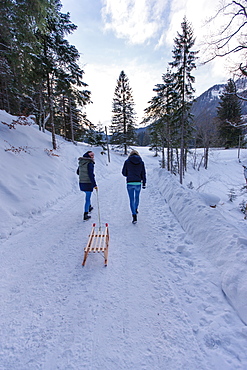 Two young women with a sled, Spitzingsee, Upper Bavaria, Germany