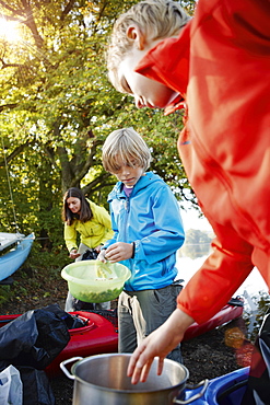 Two boys cooking by the lake Staffelsee, Seehausen, Upper Bavaria, Germany