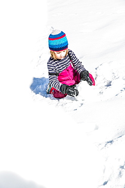 boy building a snowman in winter, Pfronten, Allgaeu, Bavaria, Germany