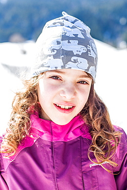 Portrait of a girl while sledging, Pfronten, Allgaeu, Bavaria, Germany