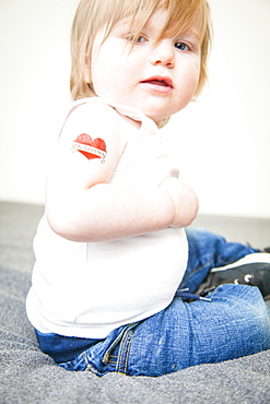 Toddler boy with stick-on tattoo saying 'Big Brother', Boston, Massachusetts, United States of America