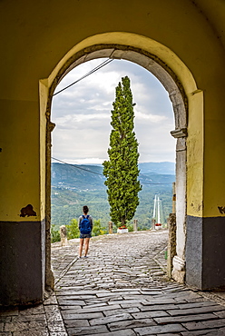 Female tourist looking out from the hilltop medieval town of Motovun, Motovun, Istria, Croatia