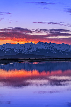 Eagle River and Eagle Beach during a brilliant coloured sunset and Chilkat Mountains, Juneau, Alaska, United States of America