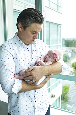 A father holds a newborn baby, Surrey, British Columbia, Canada