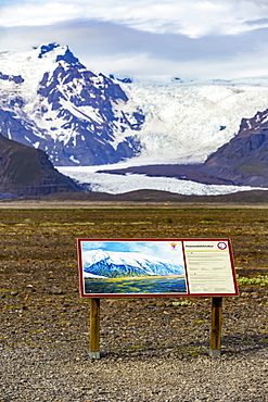 A tourism sign at this Iceland viewpoint describes Hvannadalshnjukur peak on the northwestern rim of the crater of the Oraefajokull volcano in Iceland and is the highest in Iceland, Iceland