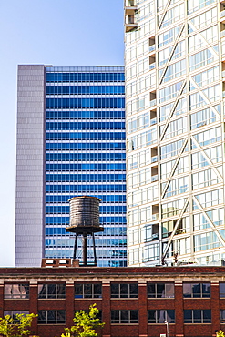 Buildings in downtown Chicago with a water reservoir on the rooftop of a residential building, showing the contrast of old and new buildings, Chicago, Illinois, United States of America