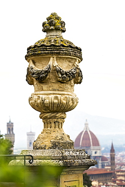 Close-up of stone urn on top of column with dome of Florence Cathedral and towers in the background, Florence, Tuscany, Italy