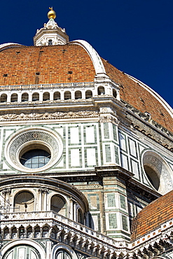 Close-up of Brunelleschi's Dome of Florence Cathedral decorative details of facade and blue sky, Florence, Tuscany, Italy