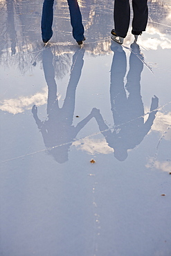 Reflection of a couple ice skating, Frog Pond, Boston Common, Boston, Suffolk County, Massachusetts, USA