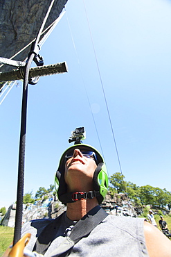 Man with spinal cord injury about to use adaptive climbing equipment up a rock face