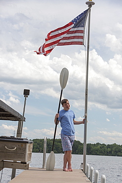 Young man with Down Syndrome preparing to use a boat at a dock