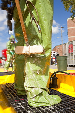 HazMat firefighter getting decontamination wash