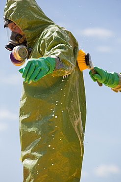 HazMat firefighter getting decontamination wash