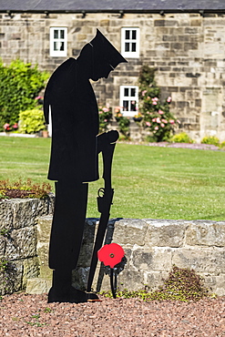 World War One memorial of a soldier with rifle and poppy; Wark, Northumberland, England