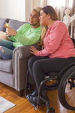 Woman who has Spinal Cord Injury reading a text with her brother