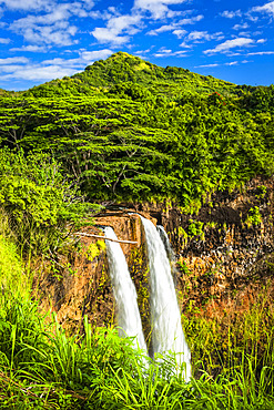 Wailua Falls drop down the cliff in lush green rainforest; Lihue, Kauai, Hawaii, United States of America