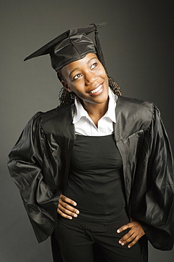 Young Woman In Graduation Cap And Gown