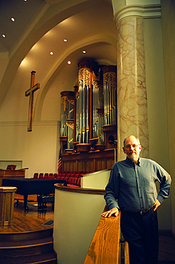 Organ manufacturer in a church with one of his company's organs, Lincoln, Nebraska, United States of America