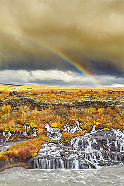 Hraunfossar Falls and a rainbow in the sky under storm clouds, near Reykholt, in west Iceland, Iceland