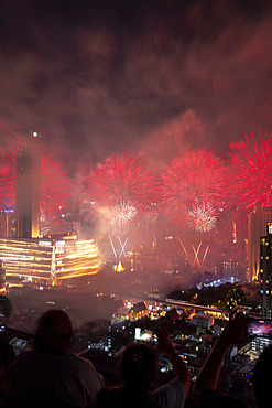 Fireworks light up the night sky over downtown Bangkok on New Years Eve, Bangkok, Thailand