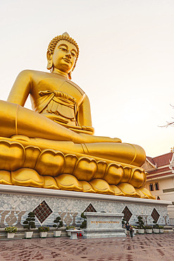 People look up at the Big Buddha against a twilight sky at Paknam Temple in Bangkok, Bangkok, Bangkok, Thailand