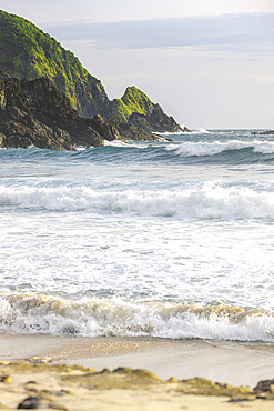 Waves rolling into shore along an Indonesian island at Telawas Beach, Mekar Sari, Praya Barat, Central Lombok Regency, West Nusa Tenggara, Indonesia