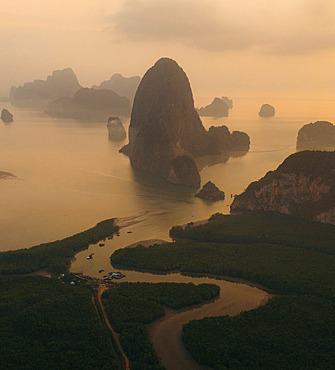 Karst rock formations at sunrise in Ao Phang Nga National Park, with mist over the Southern Thailand landscape, Ao Phang Nga, Phang-nga, Thailand