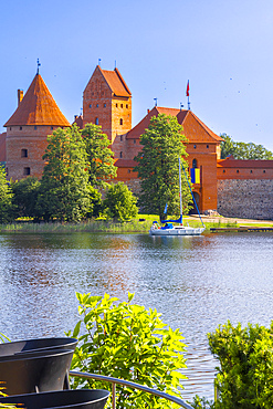 Yacht in front of Trakai Island Castle, Trakai, Lithuania, Northern Europe